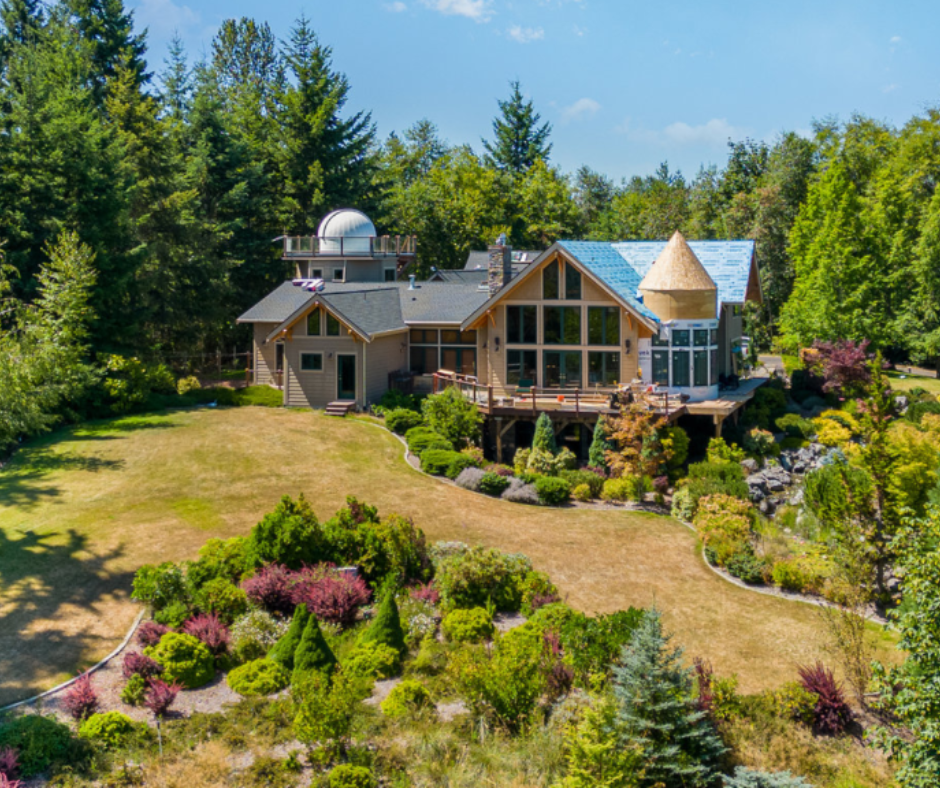 An aerial view of a large house surrounded by trees