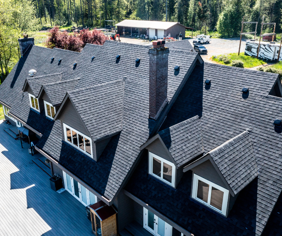 An aerial view of a large house with a black roof