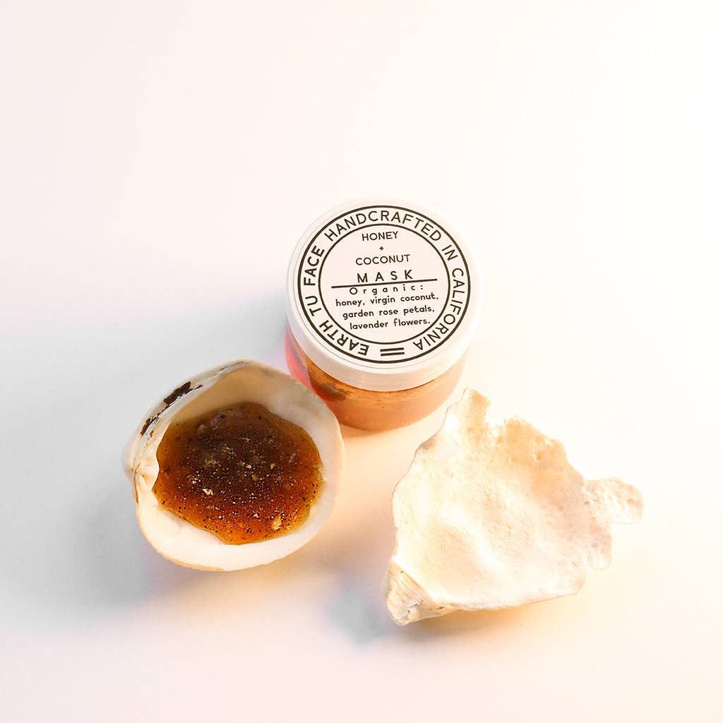 Open jar and seashells with face mask. Text on jar reads