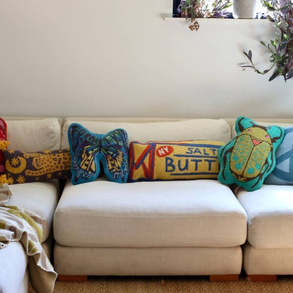 White sectional sofa with decorative, colorful throw pillows.