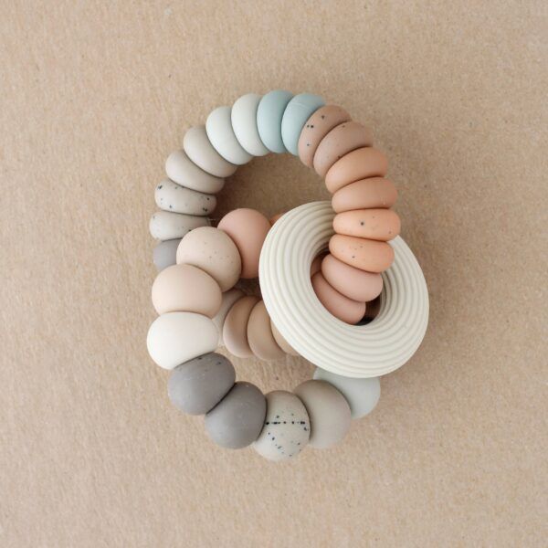 Baby teether toy with colorful silicone beads and a white ring.