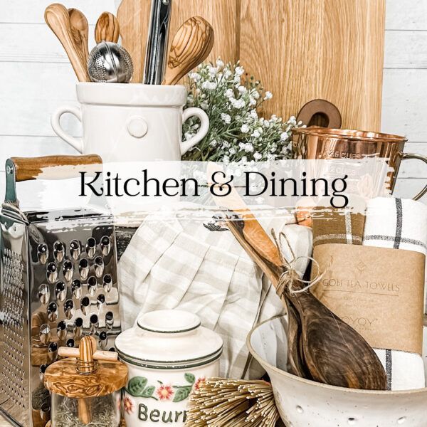 Kitchen items arranged for sale: utensils, cutting boards, towels, and a grater.