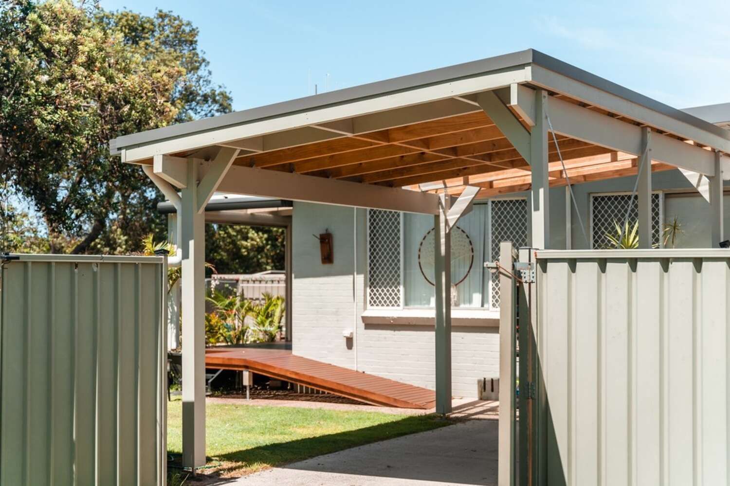 A Carport With A Wooden Roof Is In Front Of A House — Sedah Home Improvements In Port Macquarie, NSW