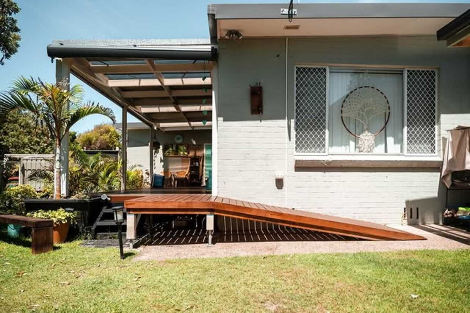 A House With A Ramp And A Wooden Deck In The Backyard — Sedah Home Improvements In Port Macquarie, NSW