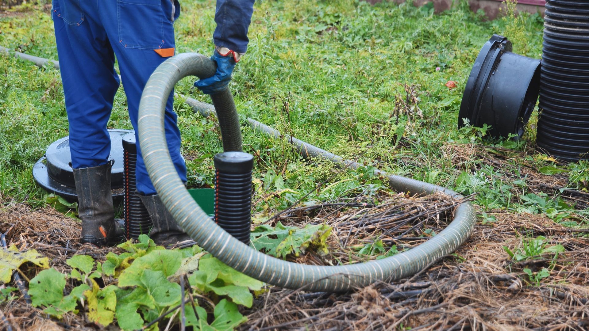 Technician performing a professional septic tank inspection at a residential property in Shelby, OH