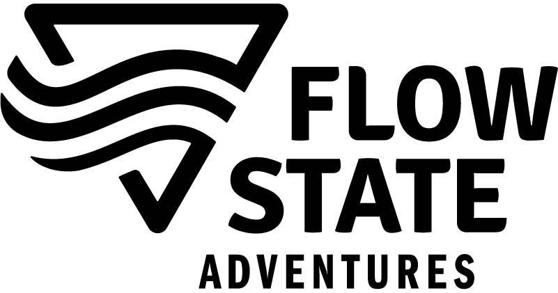 Flow State Adventures logo: Black triangle with three wavy lines,
