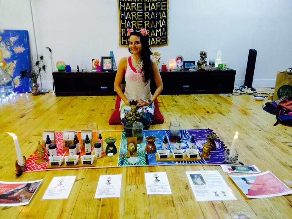 A woman sits on the floor in front of a sign that says hare hare