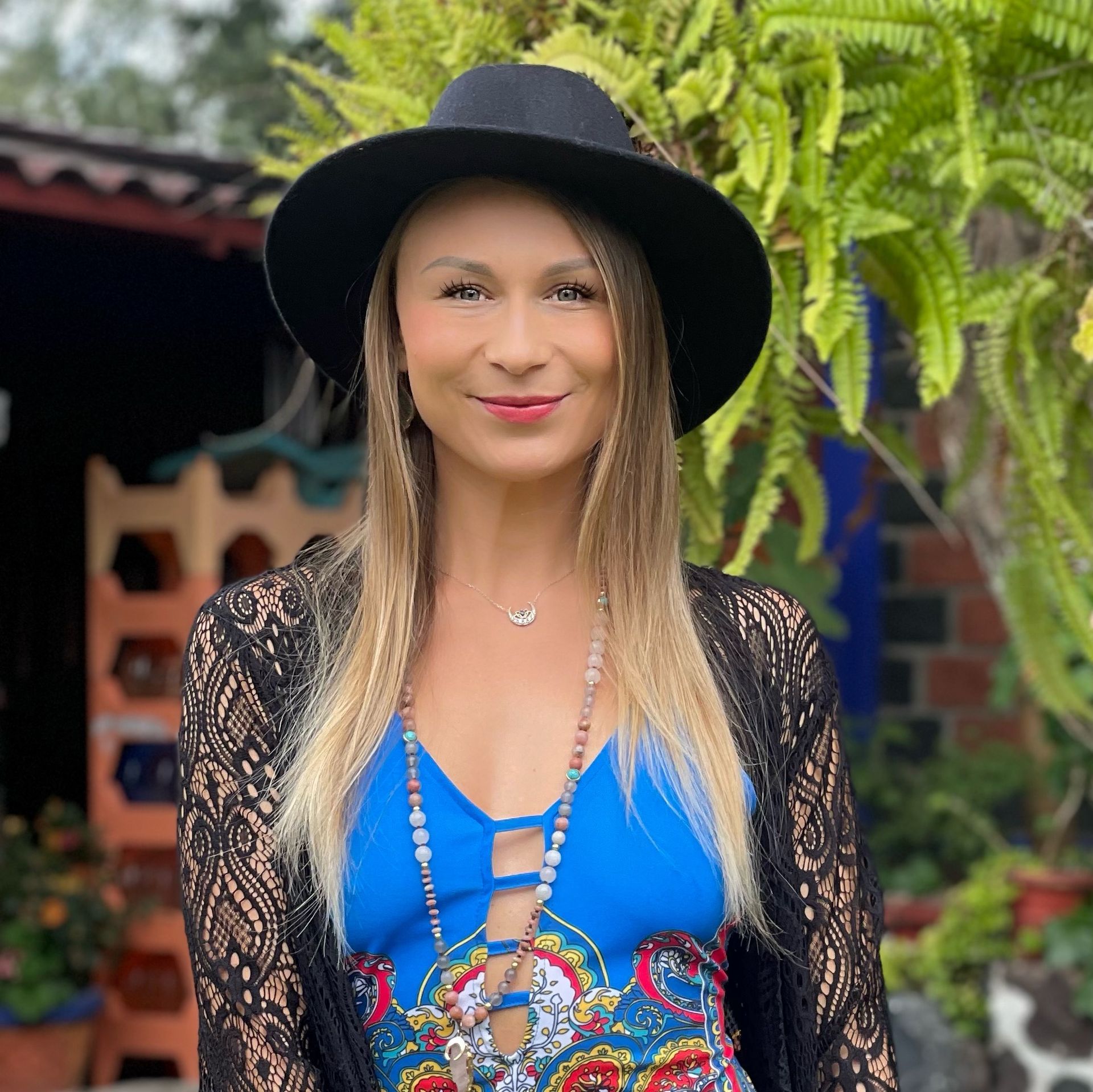 A woman wearing a black hat and a blue dress