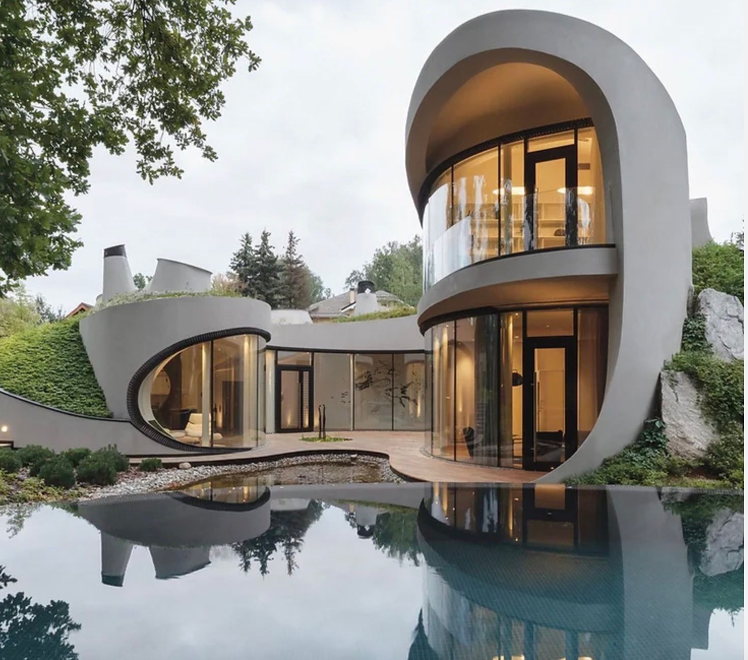 A modern house with a swimming pool in front of it