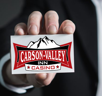 Hand holding a card with the Carson Valley Inn Casino logo: a red and black design with mountains and stars.