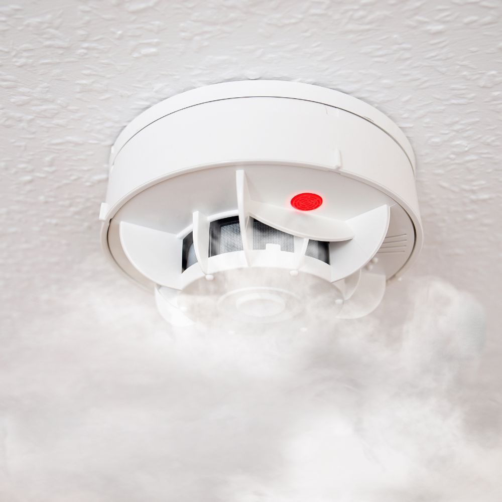 A smoke detector with smoke coming out of it