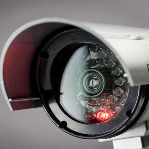 A close up of a security camera with a red light on