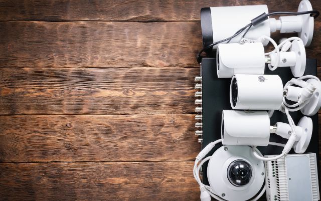 A bunch of security cameras are stacked on top of each other