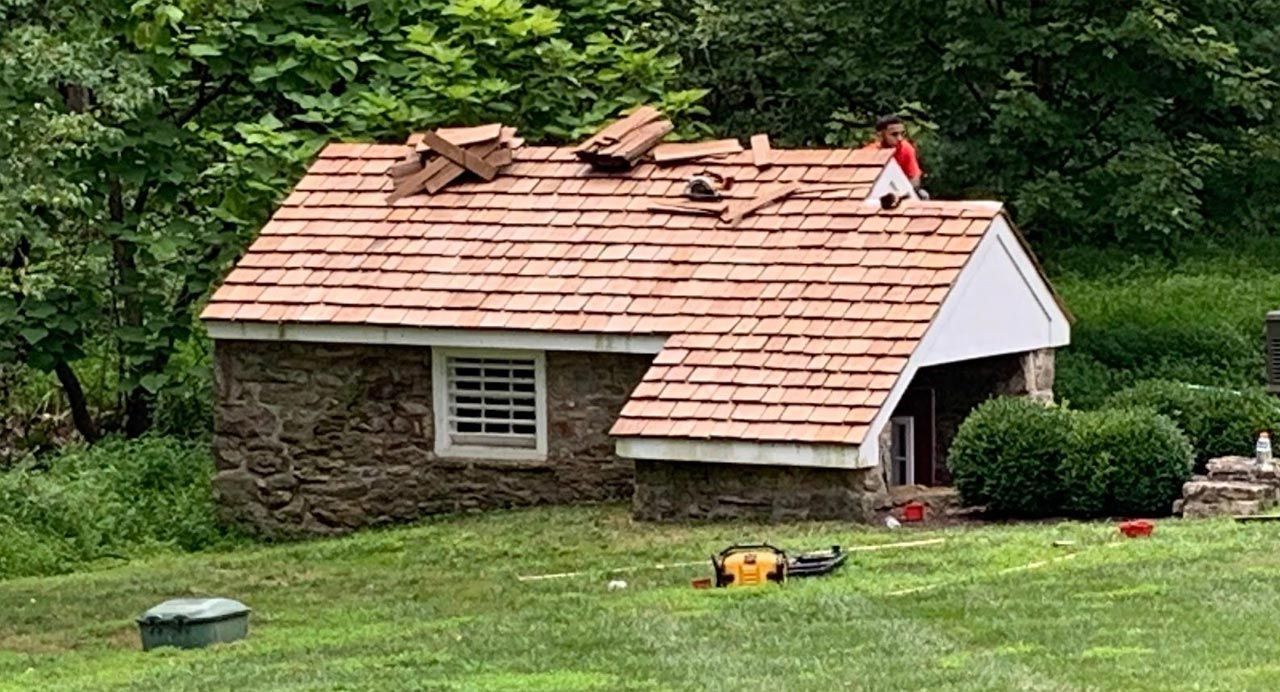 a house with a garage door and an american flag in front of it .