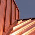 a close up of a copper roof with a blue sky in the background .