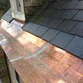 a close up of a copper gutter on a roof .