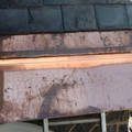 a close up of a copper gutter on a roof .