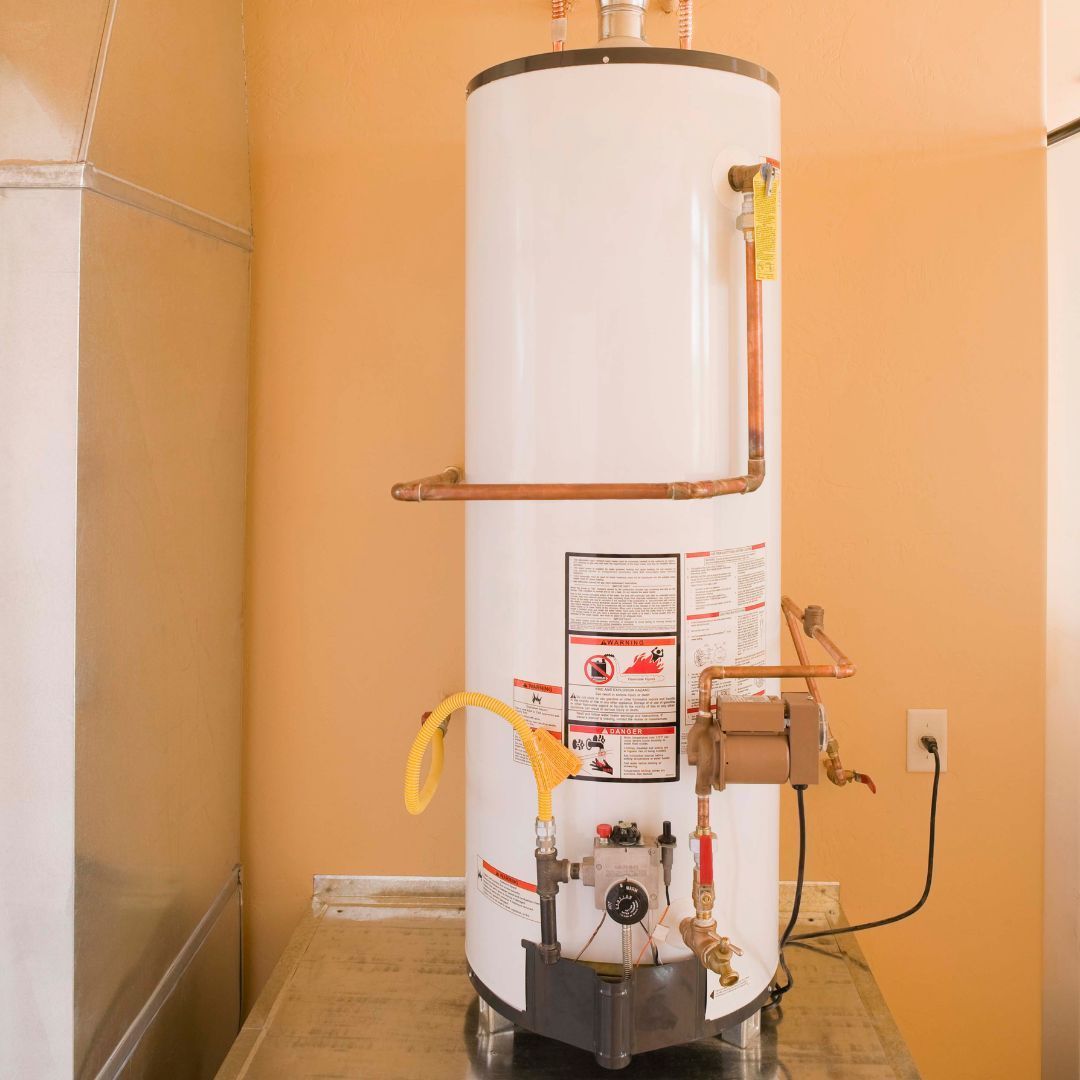 A white water heater is sitting on a counter in a room.