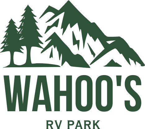 Logo for Wahoo's RV Park with green mountains, trees, and text: Wahoo's RV Park.