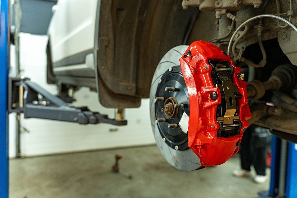 car wheel hub with a bright red brake caliper 