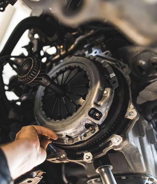 auto mechanic installing a new clutch kit for a car