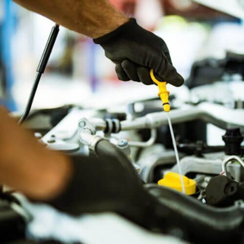 Mechanic checking oil