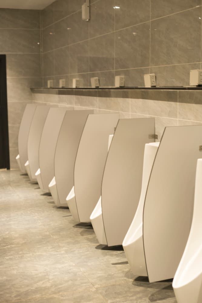 A Row of Urinals in A Public Restroom — Top End Joinery In Yarrawonga, NT