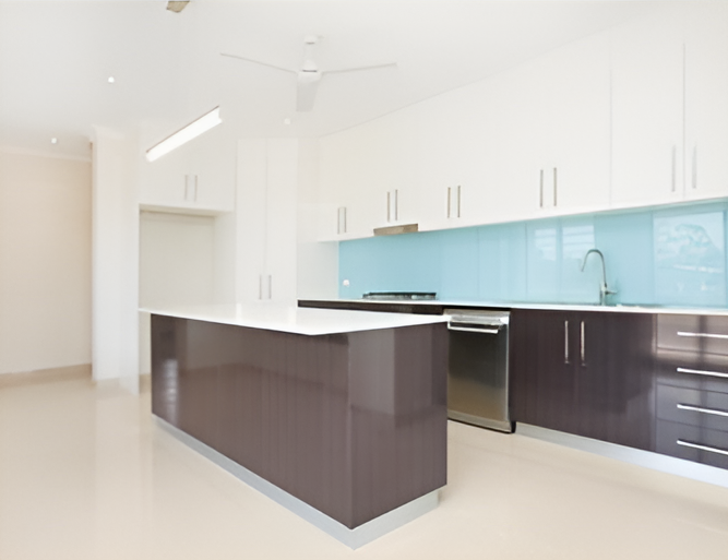 A Kitchen With White Cabinets and Stainless Steel Appliances — Top End Joinery In Palmerston, NT