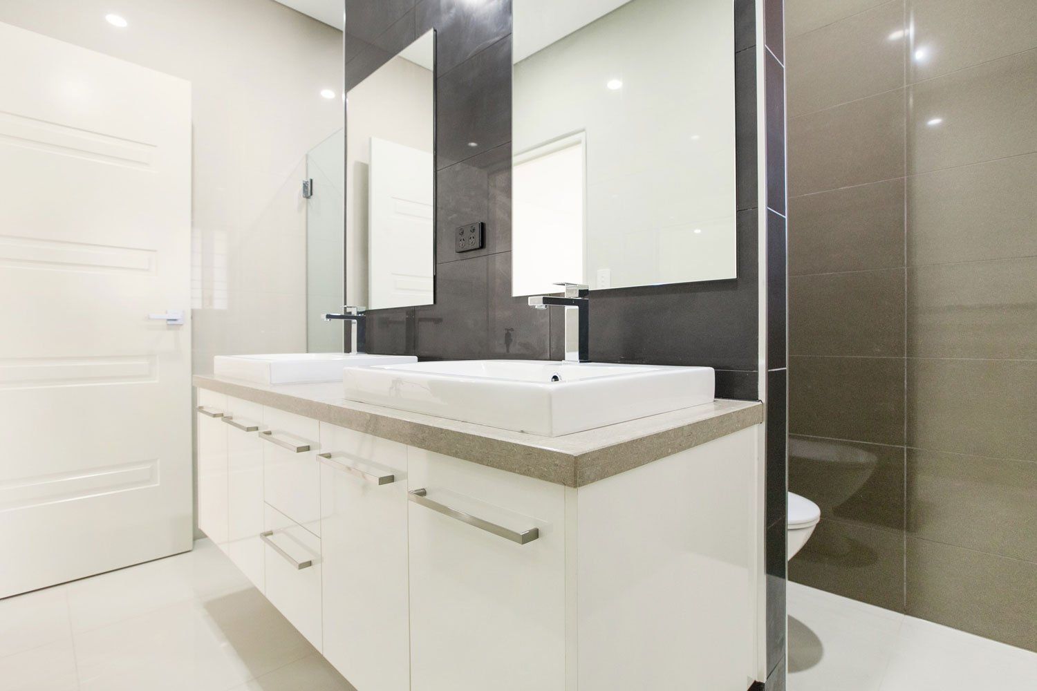 A Bathroom With Two Sinks, a Toilet and a Mirror — Top End Joinery In Yarrawonga, NT