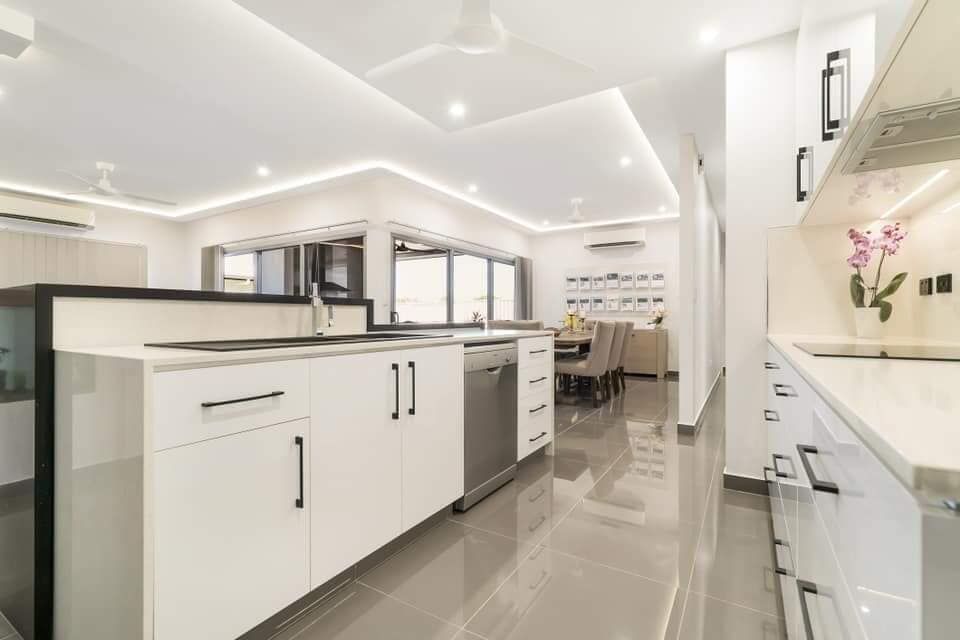 A Kitchen With White Cabinets and a Stainless Steel Dishwasher — Top End Joinery In Yarrawonga, NT