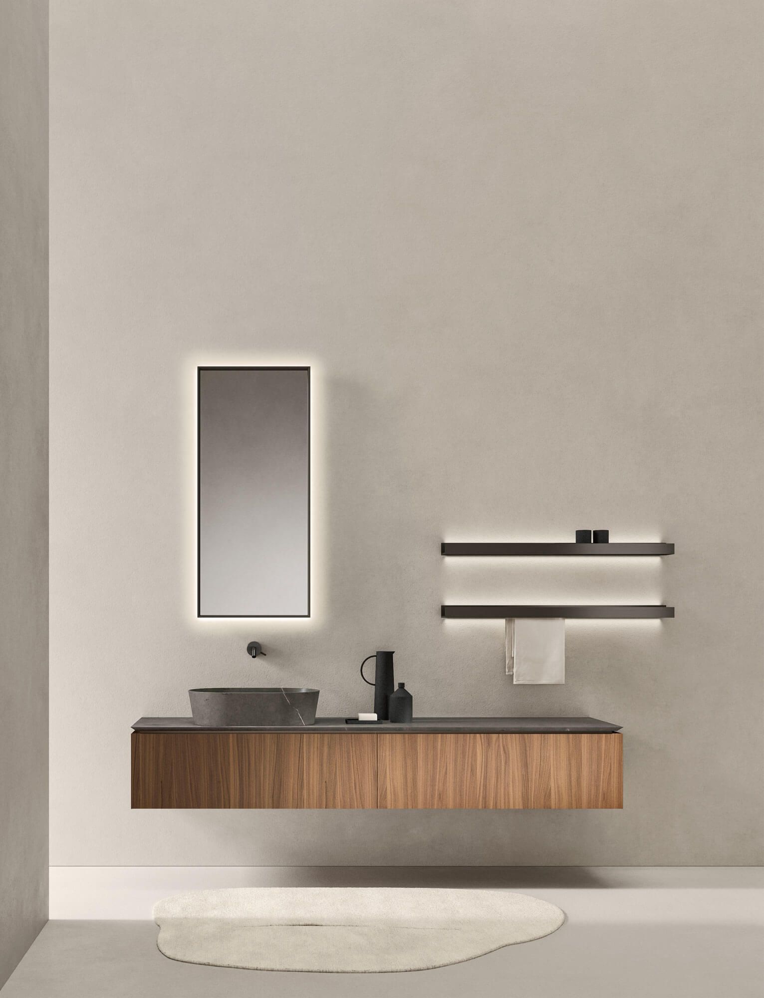 Un bagno con lavandino, specchio e portasciugamani.