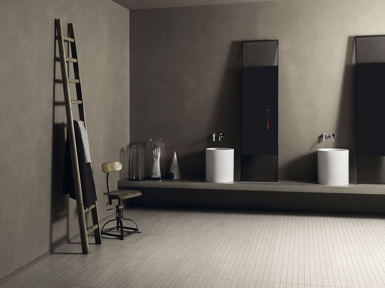 Un bagno con due lavandini e una scala sul muro
