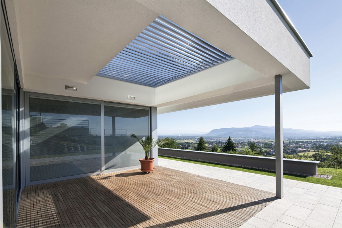 A patio with integrated louvre and a view.