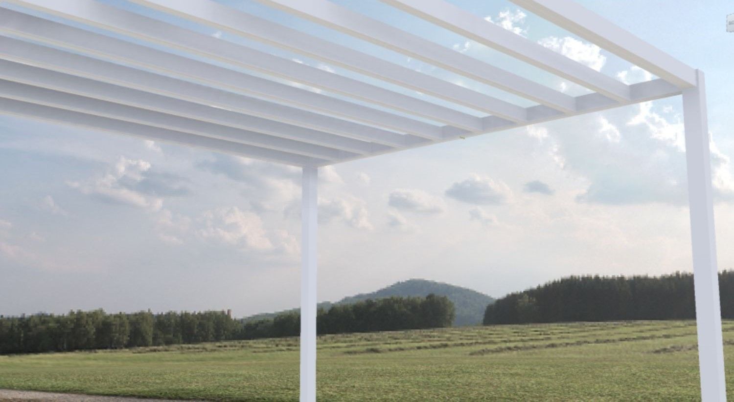 A white pergola with a clear roof is sitting in the middle of a field.