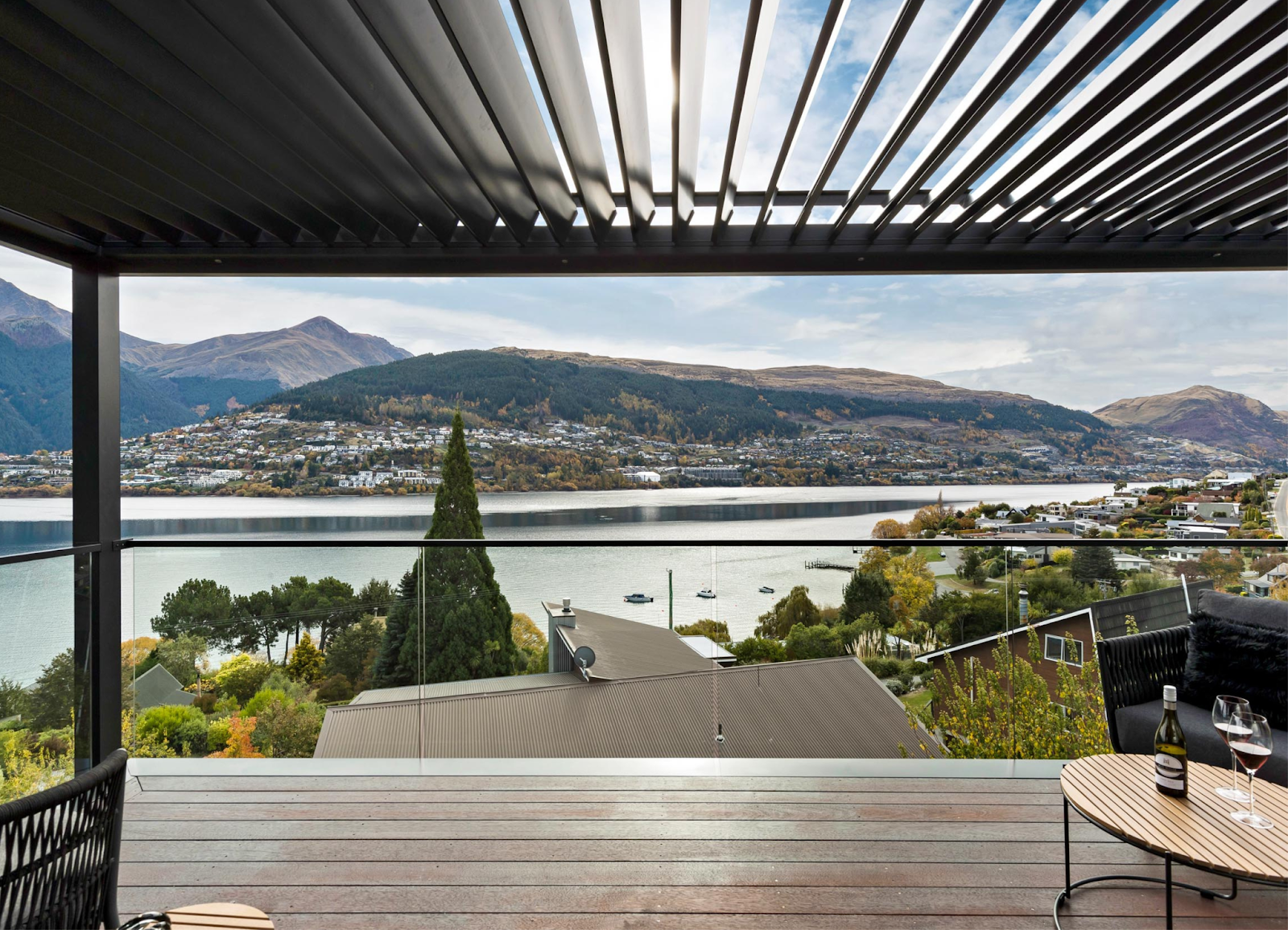 A balcony with a view of a lake and mountains.
