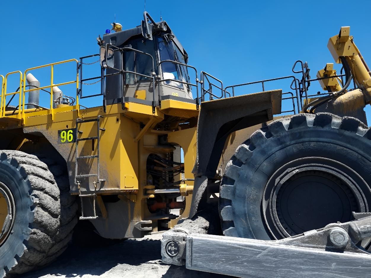 A Yellow Tractor With The Number 95 On It — Australian Specialised Machinery Glass In Mount Louisa, QLD