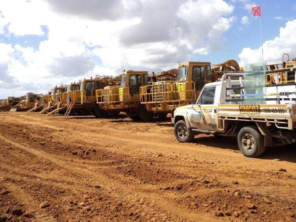 A White Truck Is Parked In Front Of A Row Of Construction Vehicles — Australian Specialised Machinery Glass In Mount Louisa, QLD