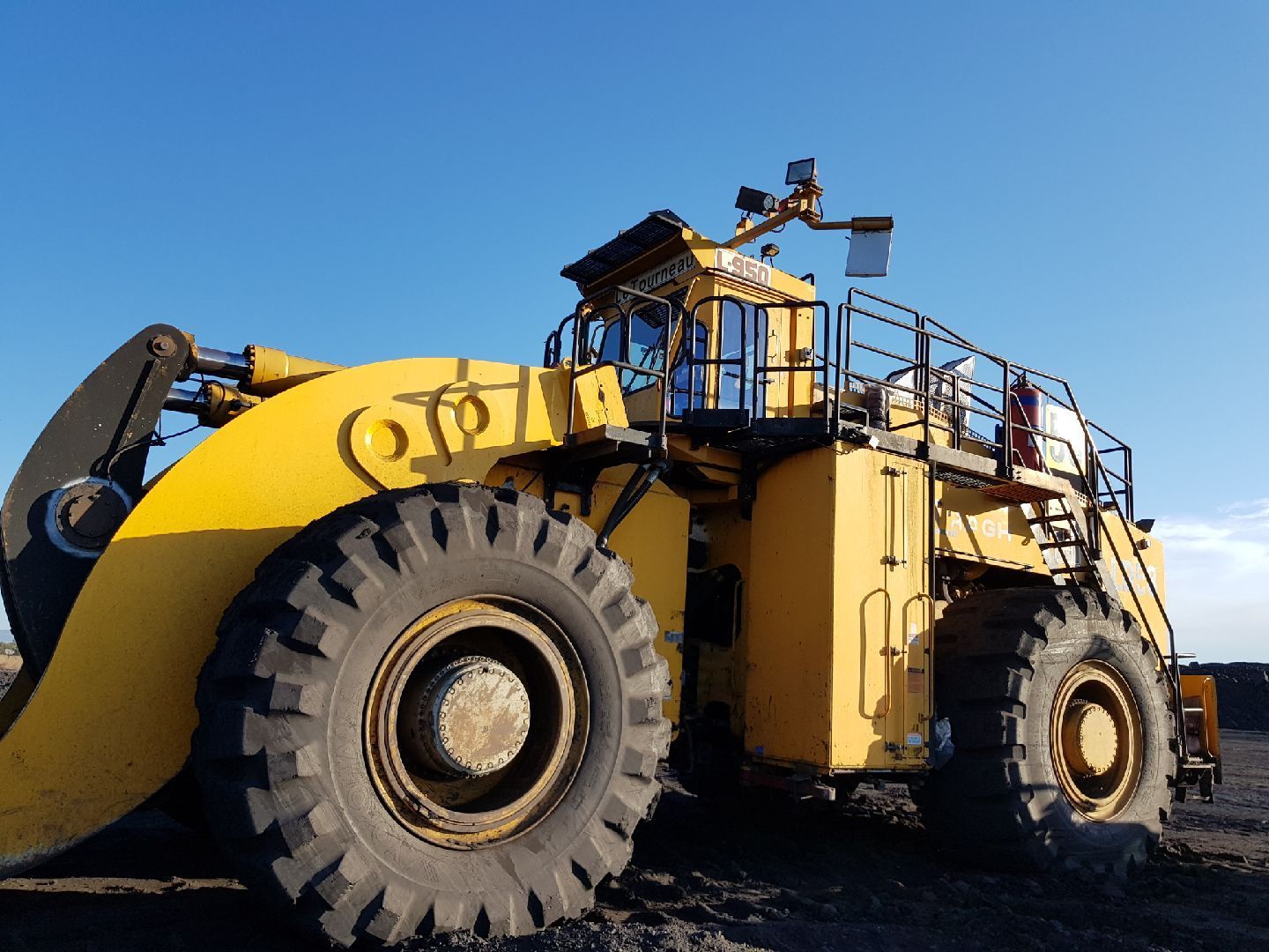 A Tractor And A Truck Are Parked Next To Each Other In A Dirt Field — Australian Specialised Machinery Glass In Mount Louisa, QLD