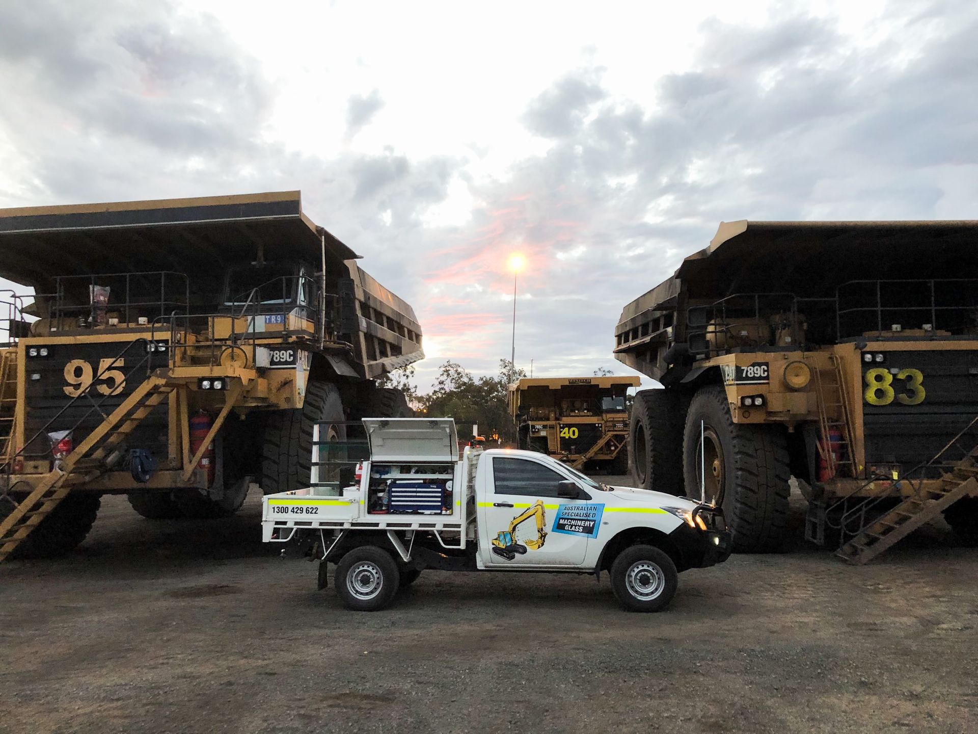 A Row Of Trucks Are Parked In A Parking Lot — Australian Specialised Machinery Glass In Mount Louisa, QLD