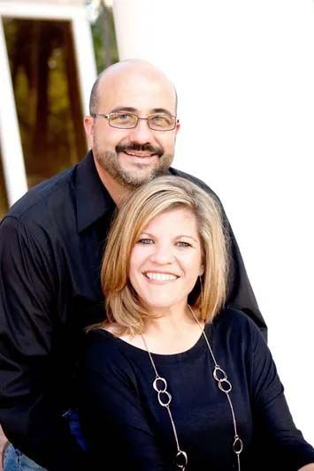 A man and a woman are posing for a picture together.