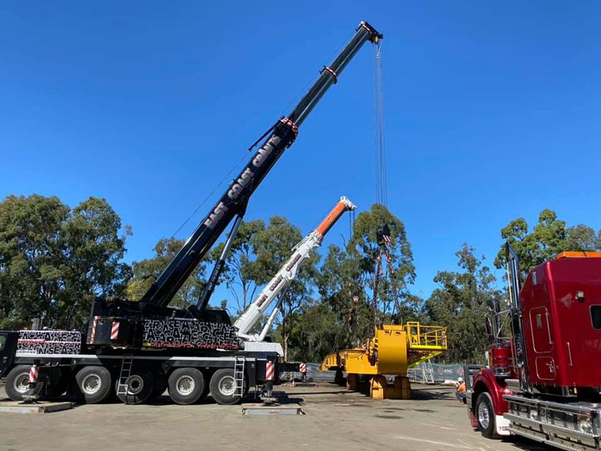A Large Crane is Lifting a Large Object in a Parking Lot — East Coast Cranes in Cairns, QLD
