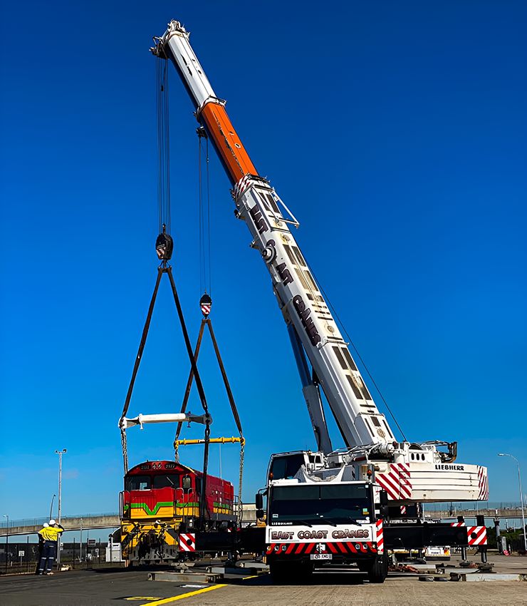 A Large Crane is Lifting a Train in a Parking Lot — East Coast Cranes in Newcastle, NSW