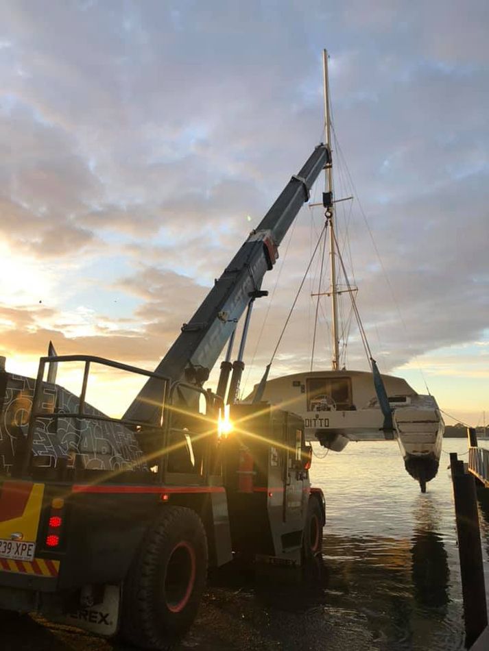 A Crane is Lifting a Boat Into the Water — East Coast Cranes in Rockhampton, QLD