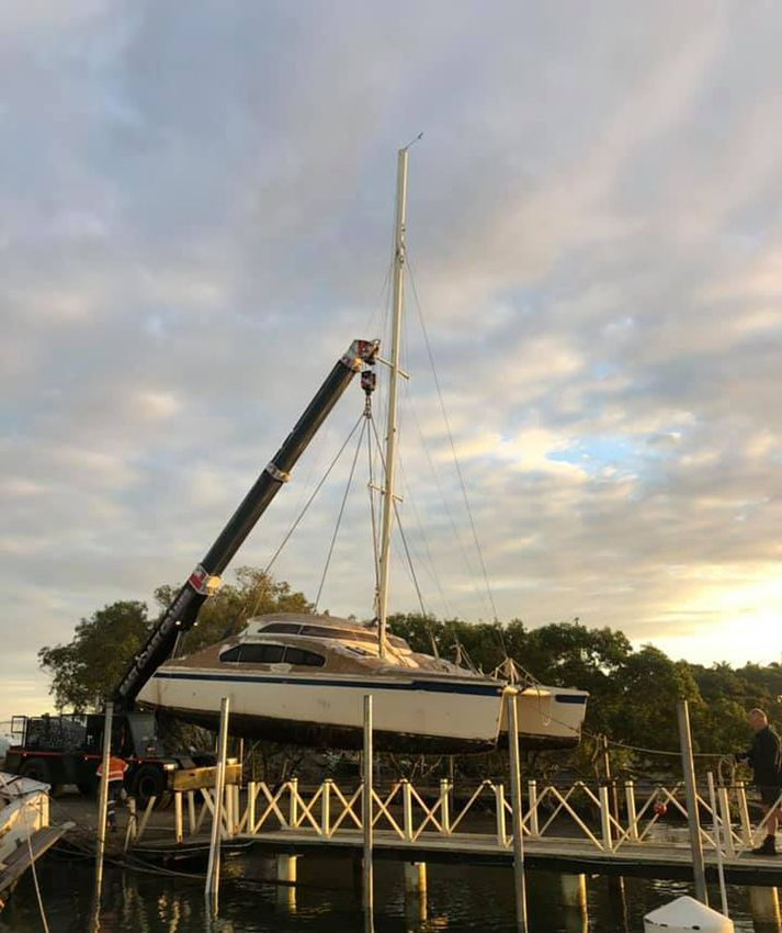 A Boat is Being Lifted Into a Dock by a Crane — East Coast Cranes in Port Macquarie, NSW
