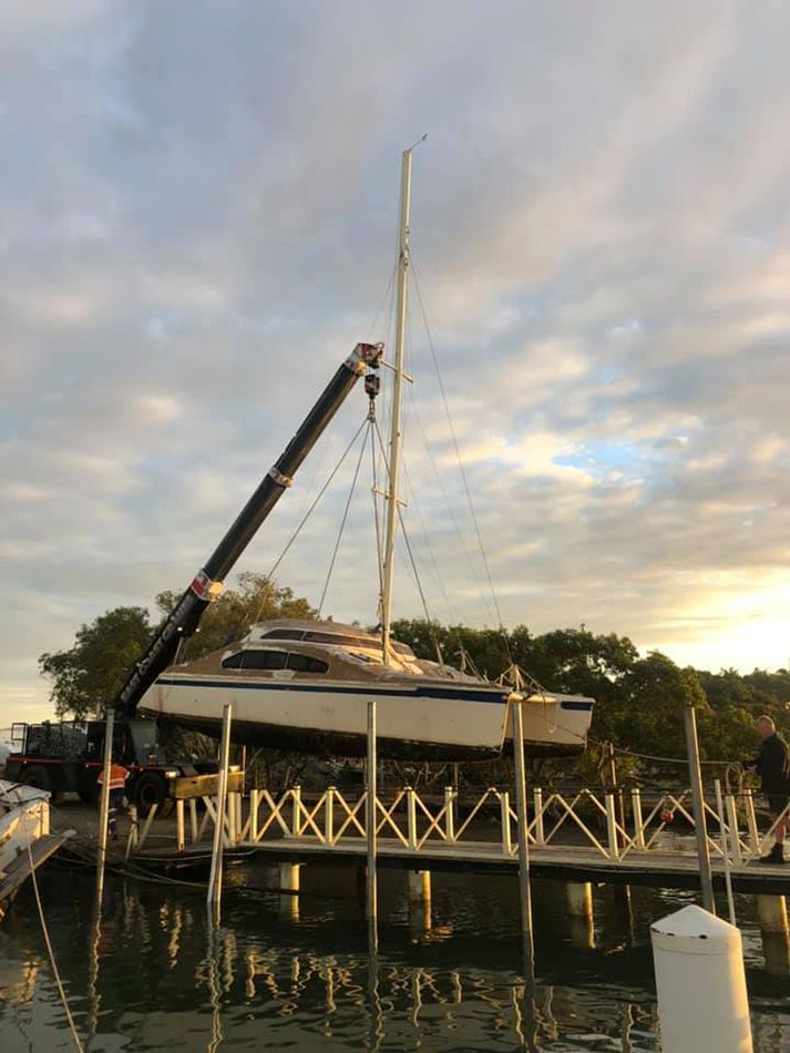 A Boat is Being Lifted Into the Water by a Crane — East Coast Cranes in Ormeau, QLD
