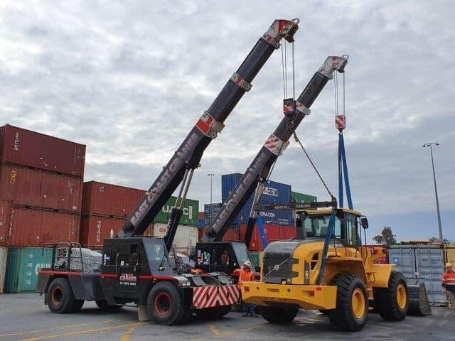 Two Crane Trucks Are Parked Next to Each Other in a Parking Lot — East Coast Cranes in Cairns, QLD