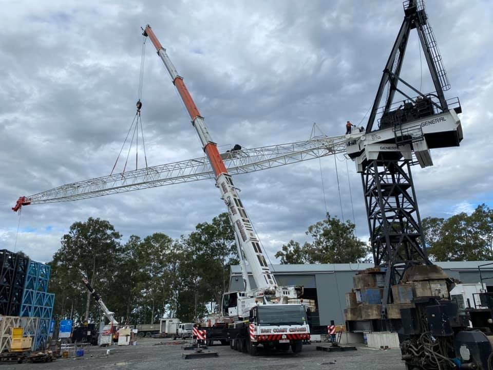 A Large Crane is Being Lifted by a Truck in a Parking Lot — East Coast Cranes in Cairns, QLD