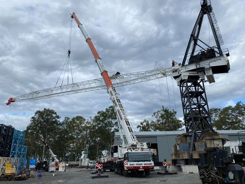 A Large Crane is Being Lifted by a Truck in a Parking Lot — East Coast Cranes in Rockhampton, QLD