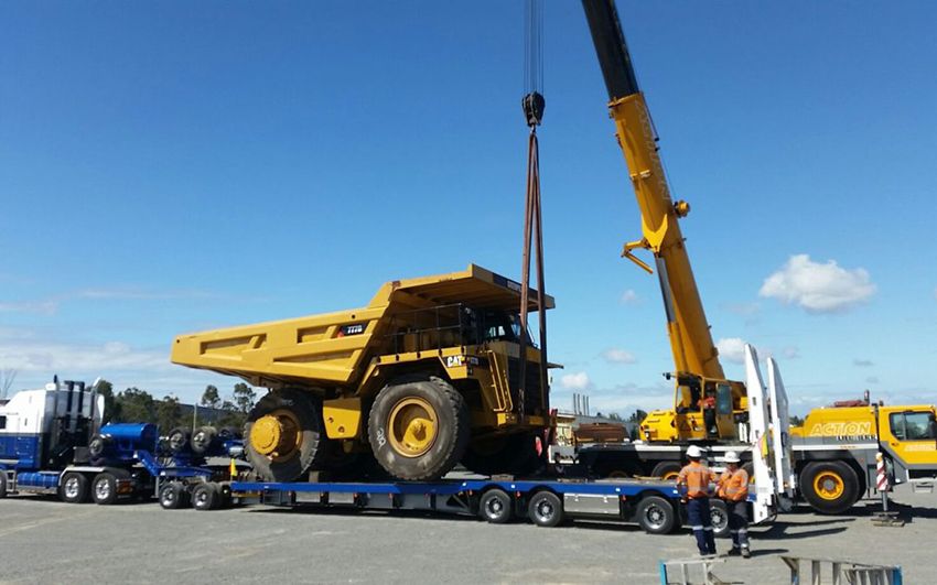 Yellow Mining Truck Being Lifted by a Crane Onto a Low-loader Trailer, Outdoors — East Coast Cranes in Ormeau, QLD