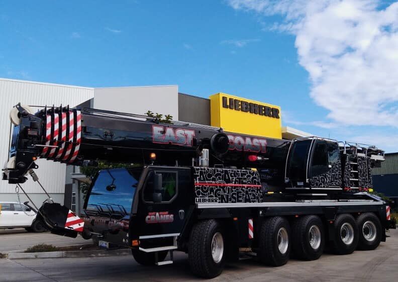 A Large Crane is Parked in Front of a Building — East Coast Cranes in Ormeau, QLD